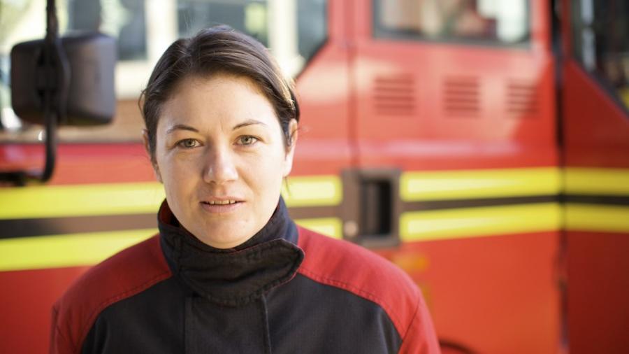 female-firefighter-by-engine