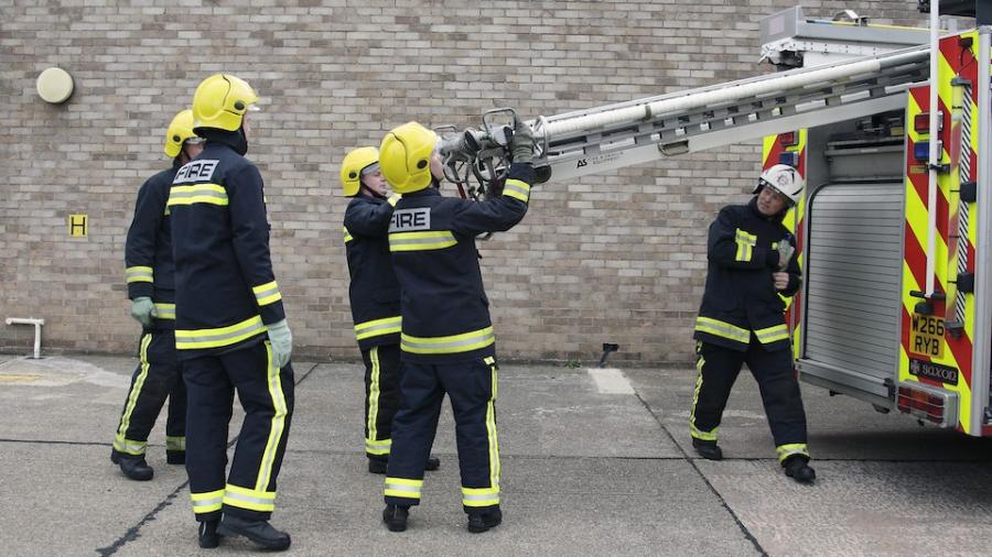 firefighters-putting-ladder-in-engine