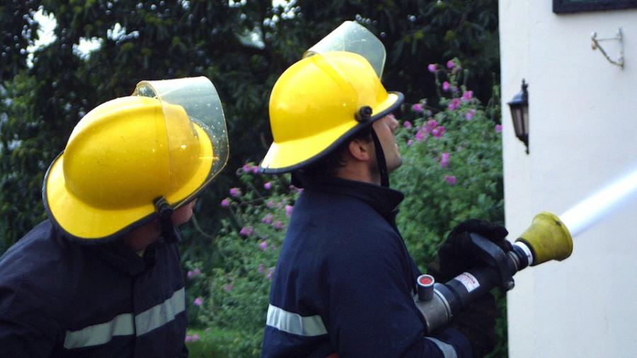 two-firefighters-hosing-house