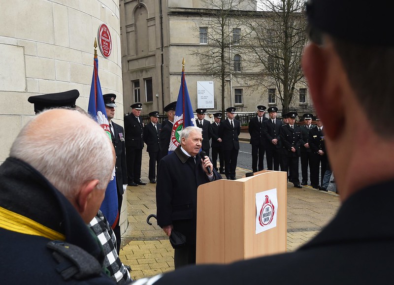 Man speaking at Leonard McCartney and Lexie Wylie Red Plaque unveiling