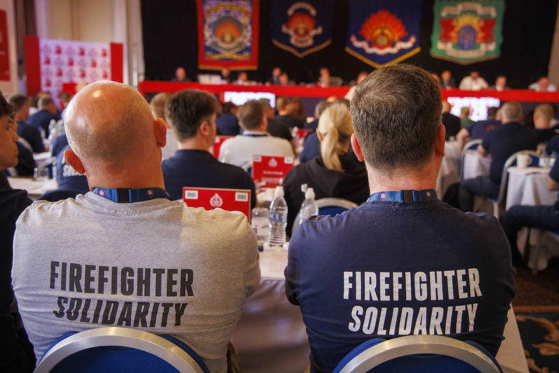 Two firefighters wearing firefighter solidarity t-shirts