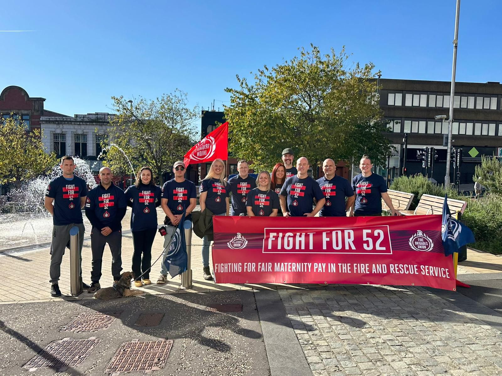 FBU members hold Fight 52 banner outside fire authority building