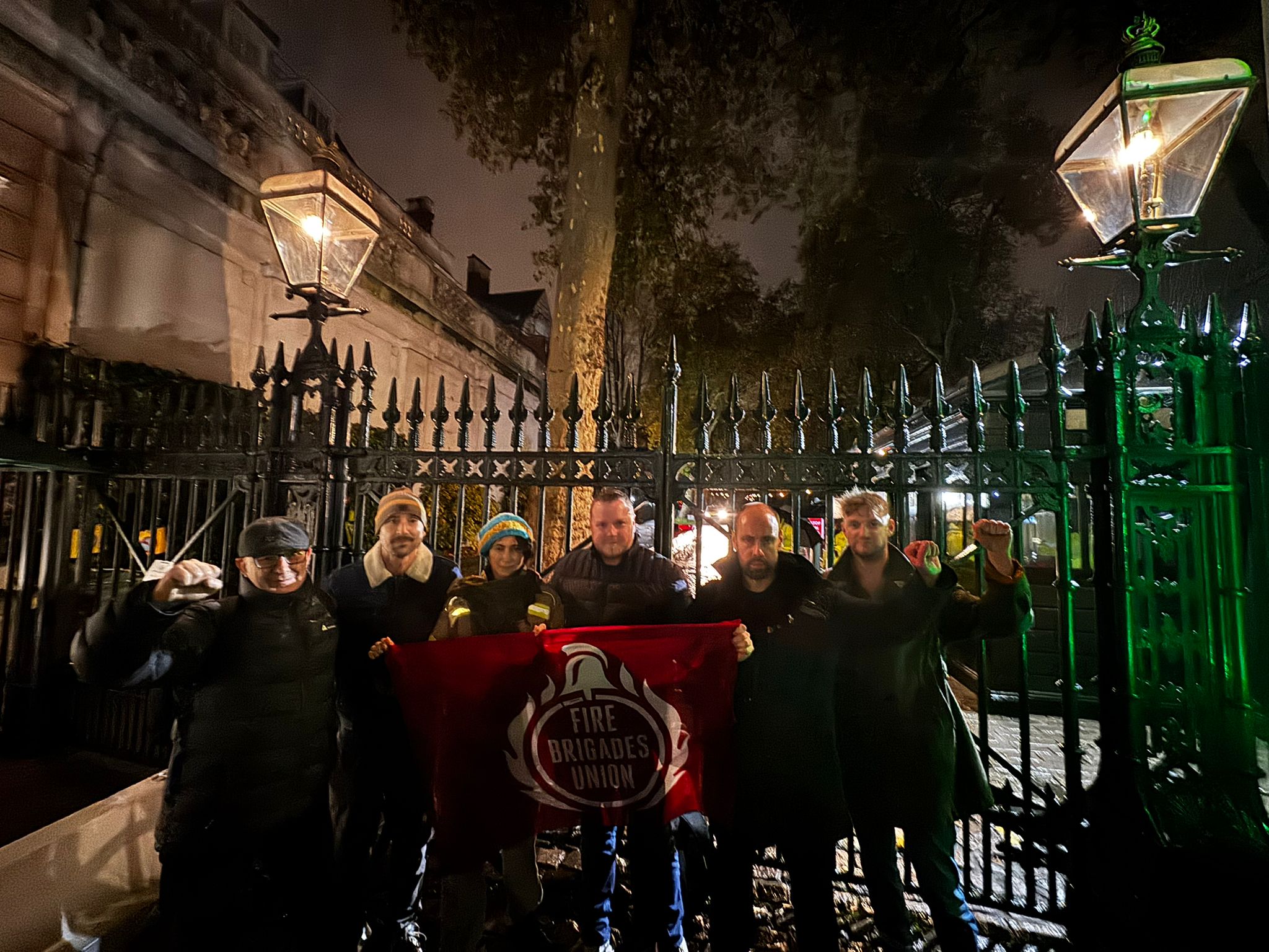 Group of protestors holding FBU flag outside Israeli embassy gates