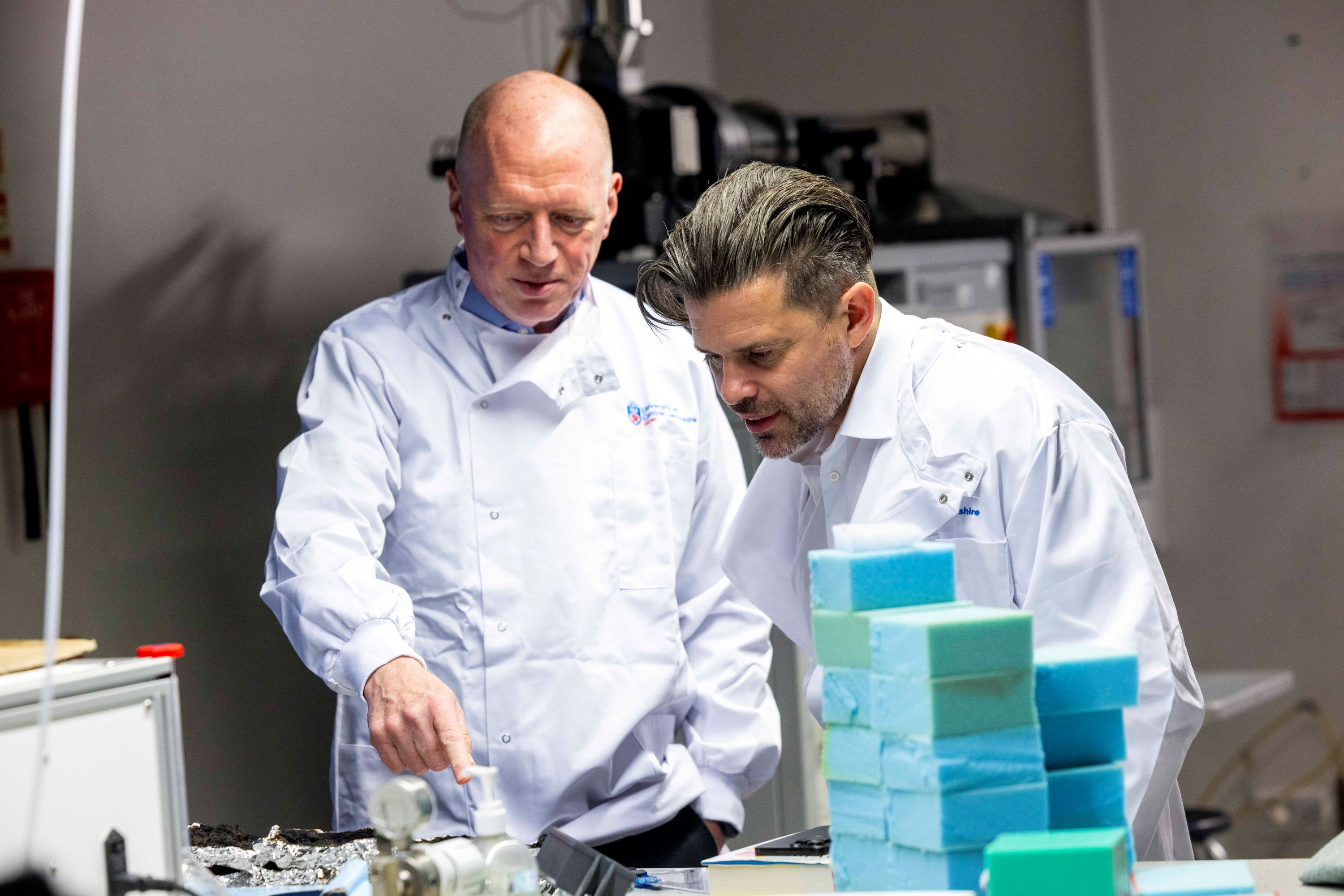 Matt Wrack and Riccardo la Torre in lab coats at the university of central lancashire