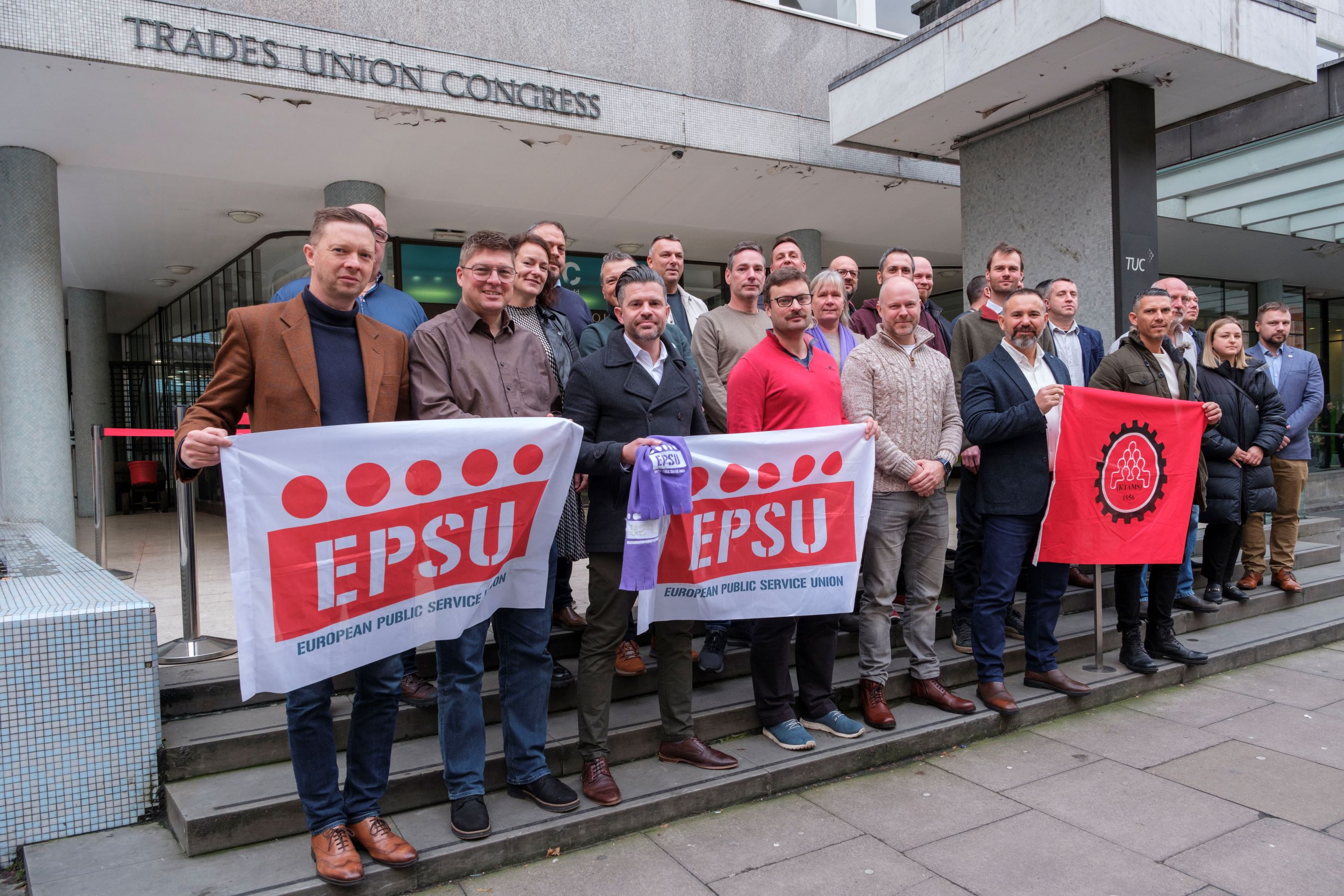 Firefighters from across Europe hold an EPSU banner outside Trades Congress House