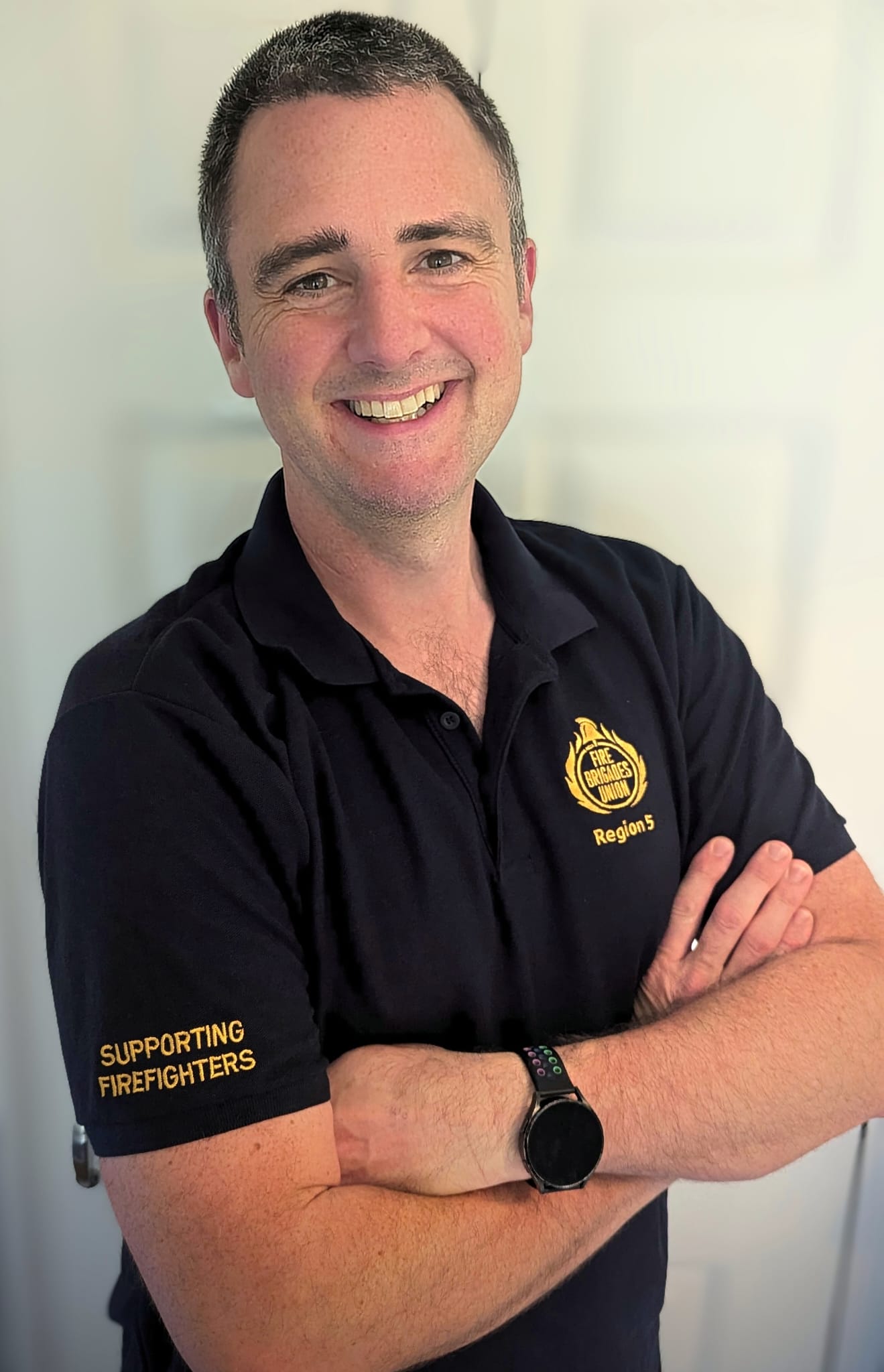 Matthew Black smiling at camera wearing FBU polo shirt