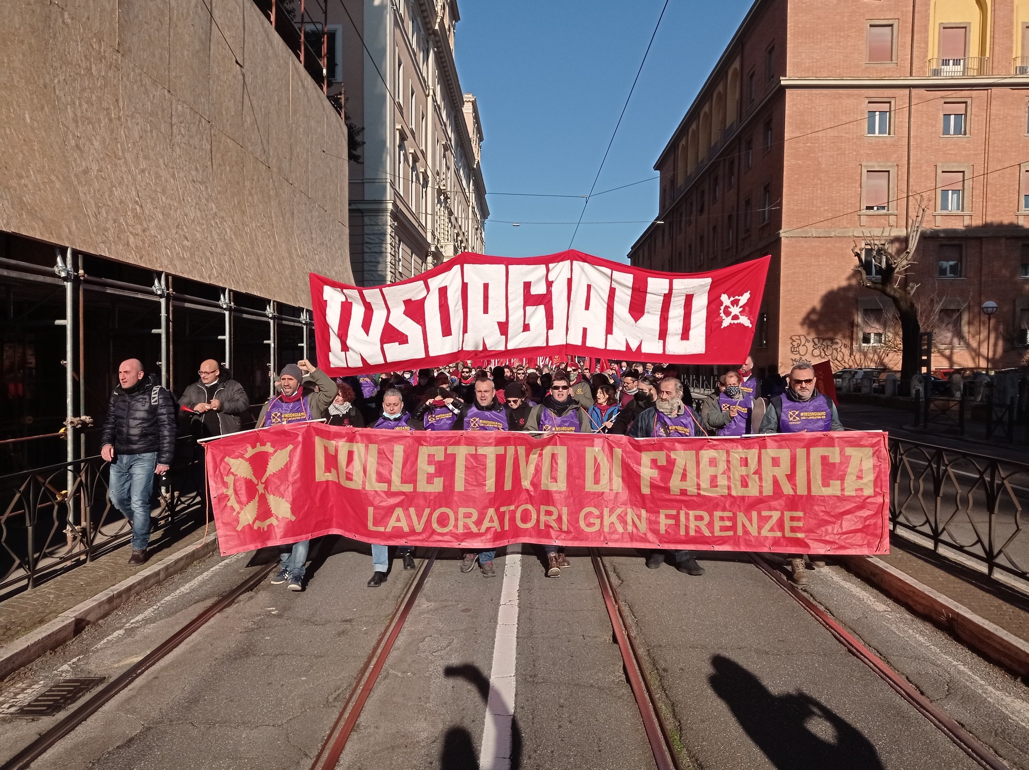 Workers from the GKN factory march with a banner reading "rise up" in Italian