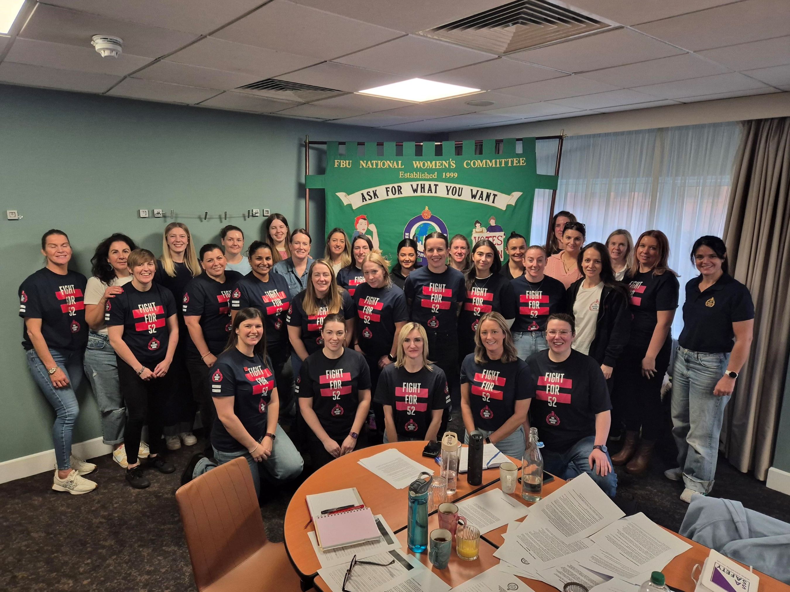 FBU members at the annual national women's committee general meeting wearing Fight for 52 t shirts