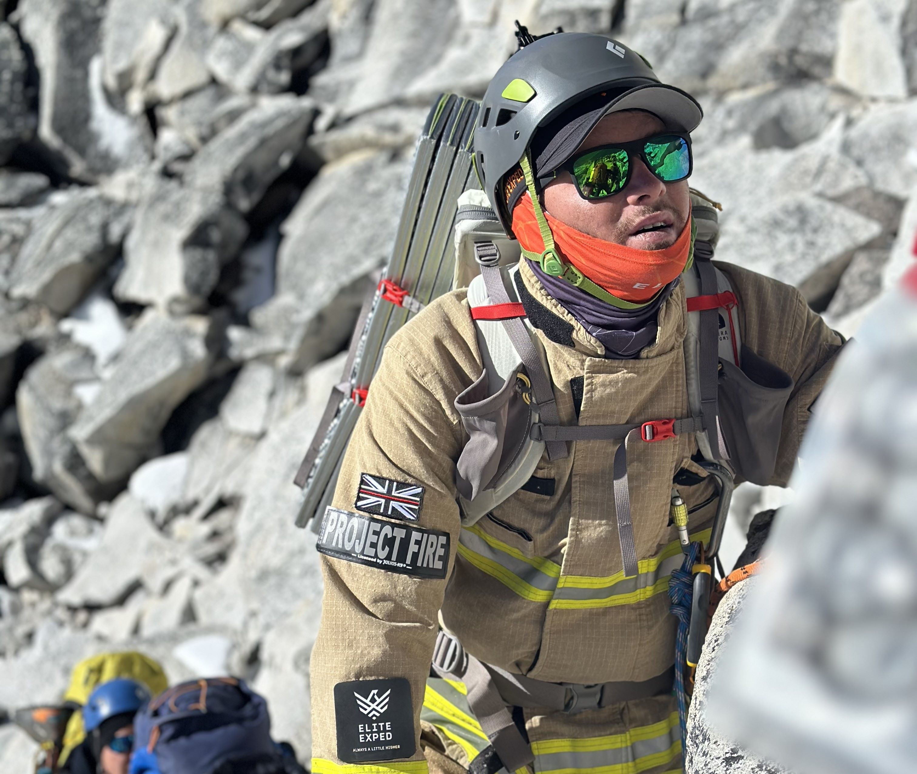 Firefighter in kit climbing a mountain