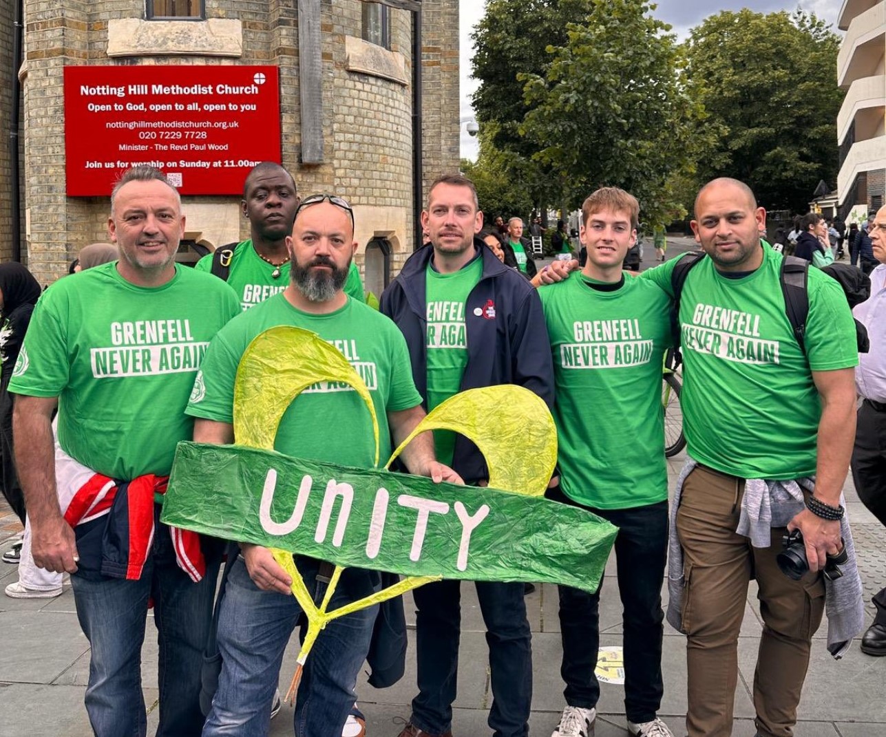 Steve Wright and FBU officials hold a 'unity' placard at the Grenfell silent walk