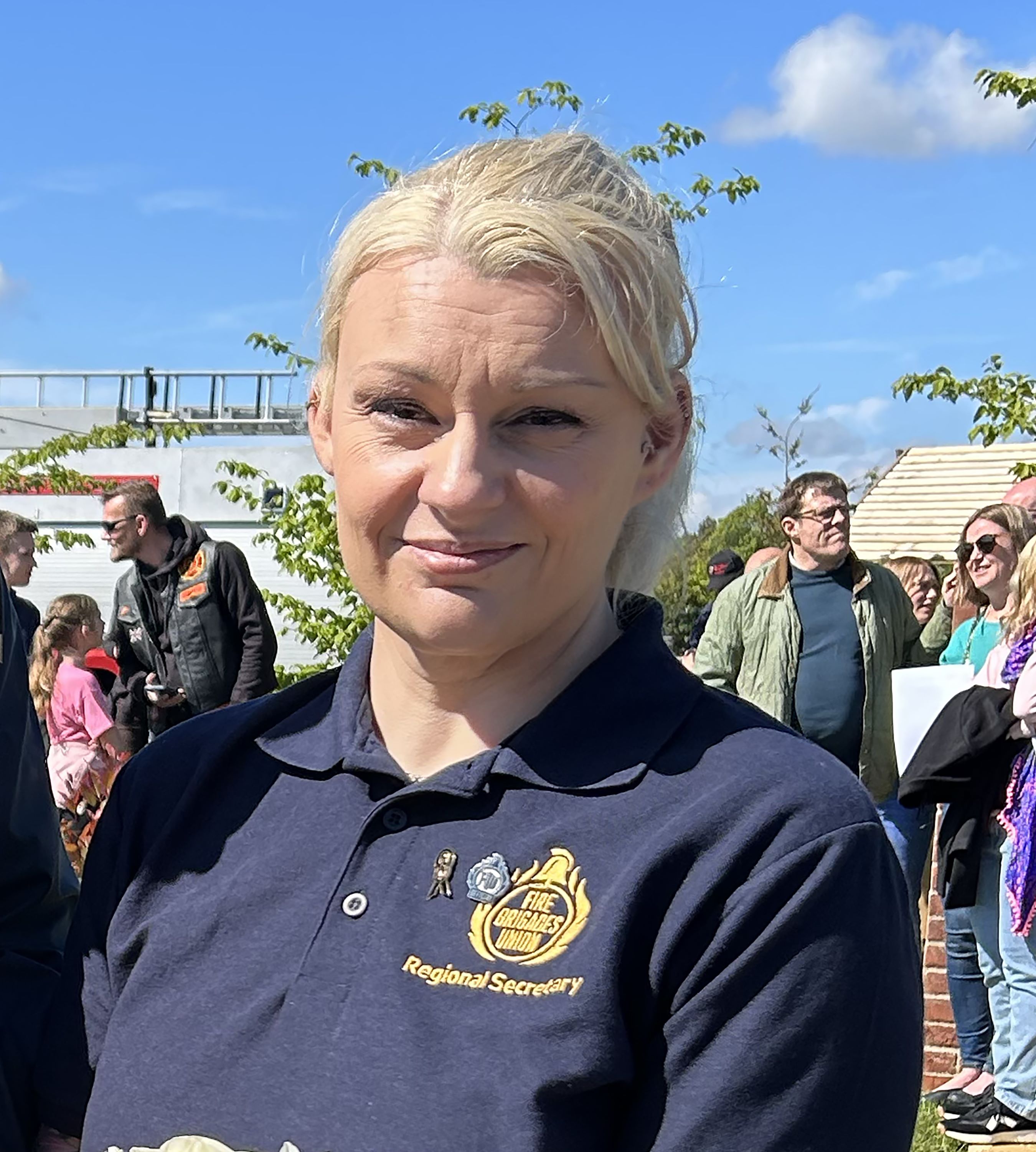 Rebecca Lewington smiling at camera wearing FBU polo shirt