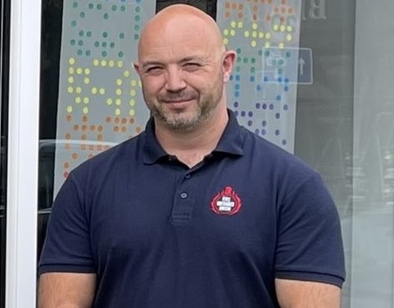 Mark Thomas standing looking at camera in FBU polo shirt