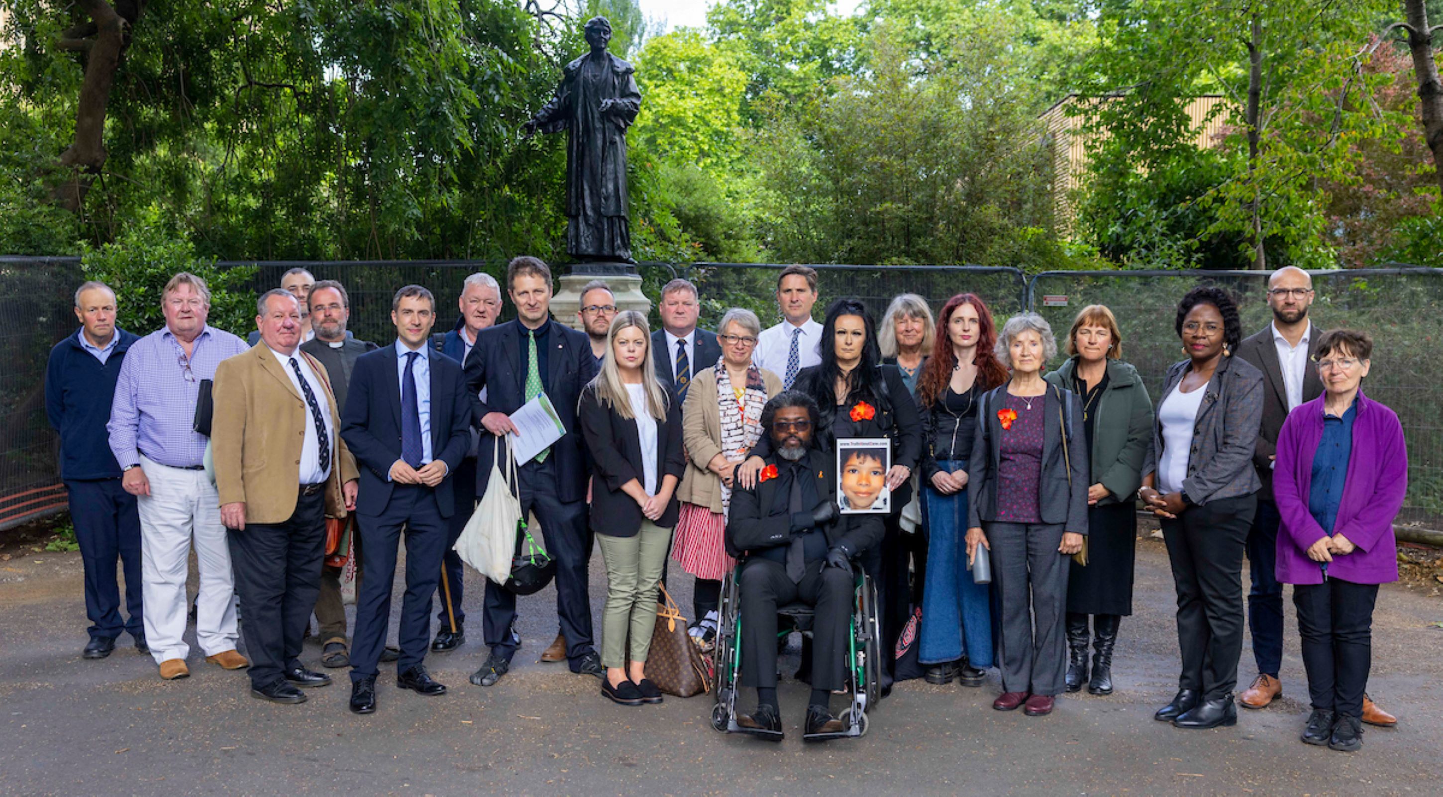 Group photo of campaigners and MPs outside college green