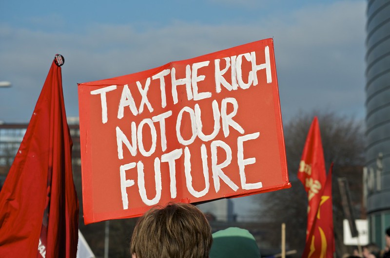 Placard reading tax the rich not our future