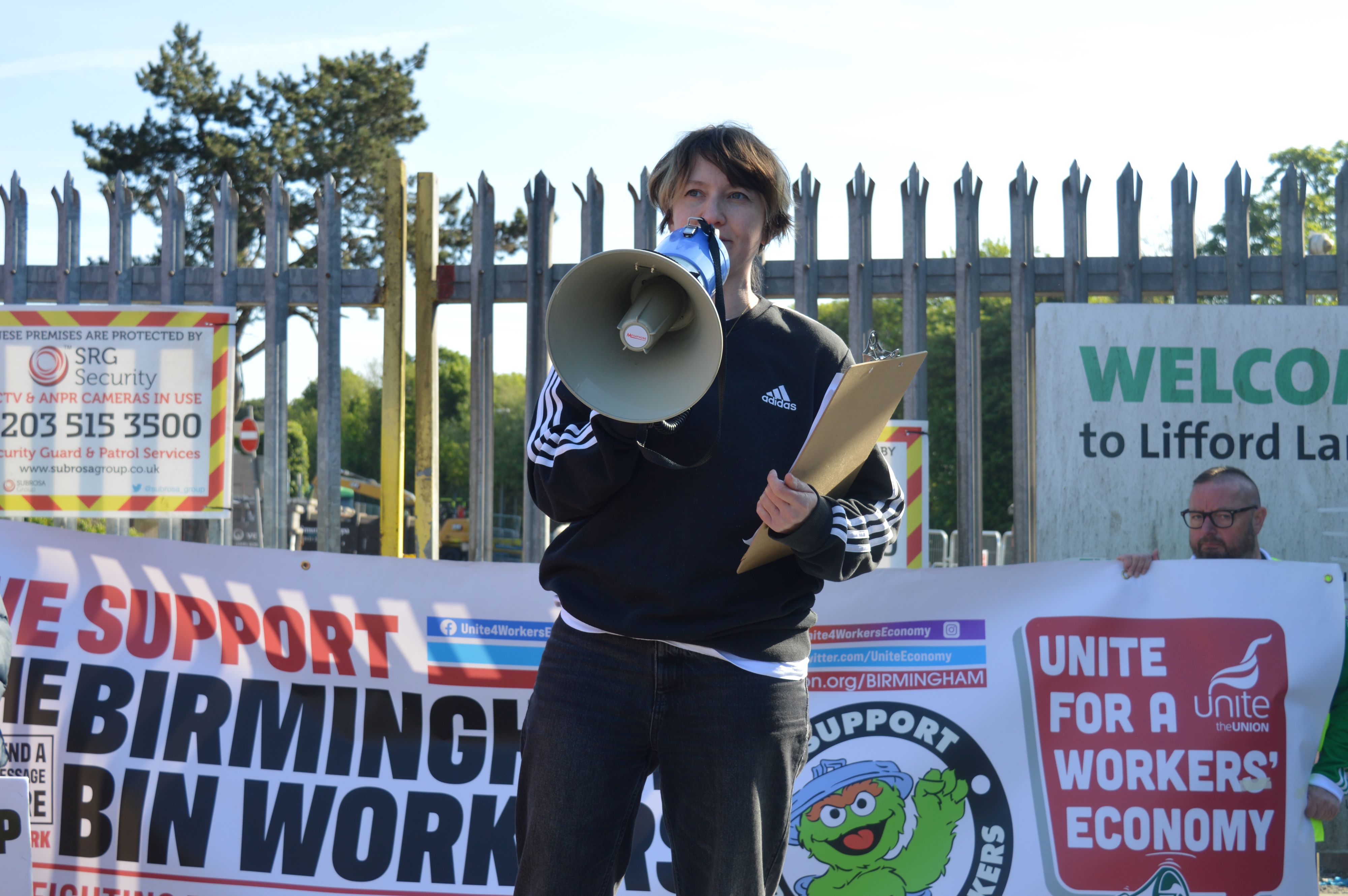 Paula Dunne of Strike Map with a megaphone at the bin strike picket line