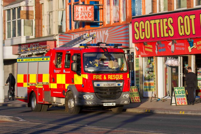 A fire engine in Blackpool outside a colourful arcade