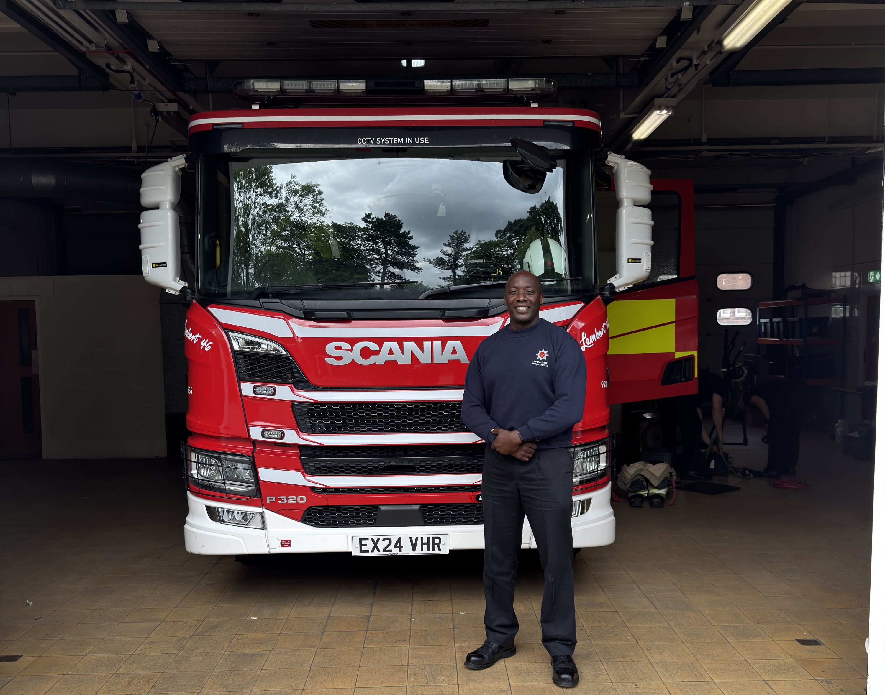 Dwight Williams standing next to a fire engine