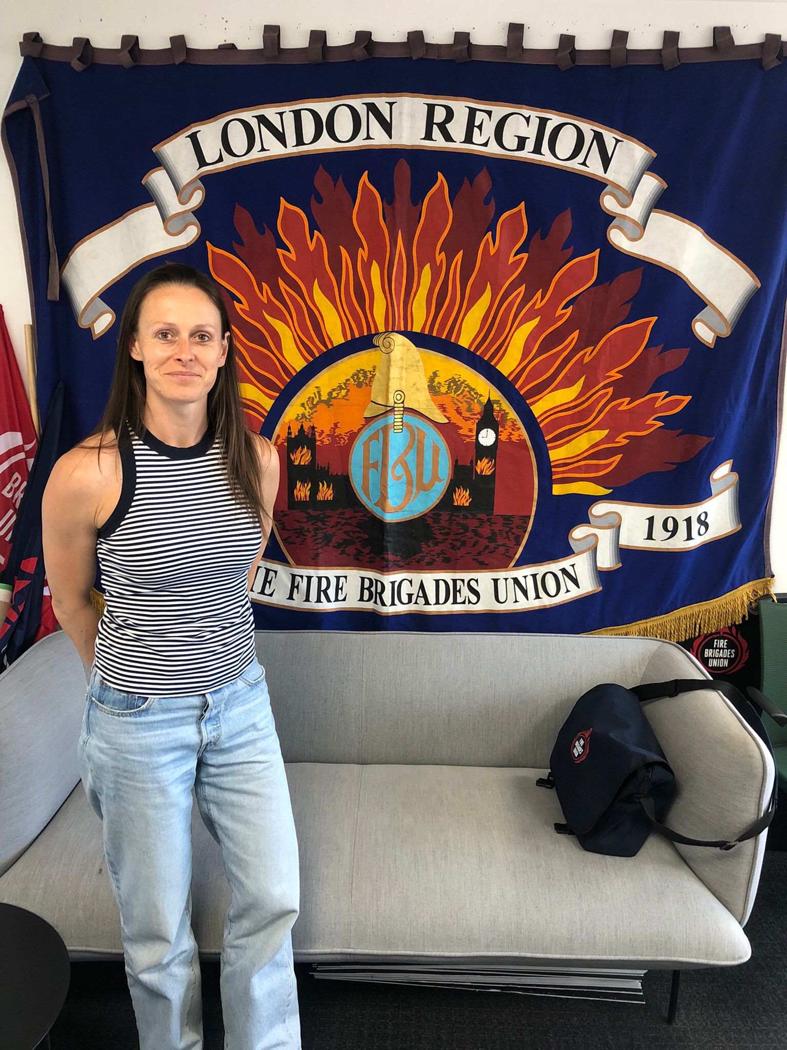 Annabel Green in front of the Fire Brigades Union national banner