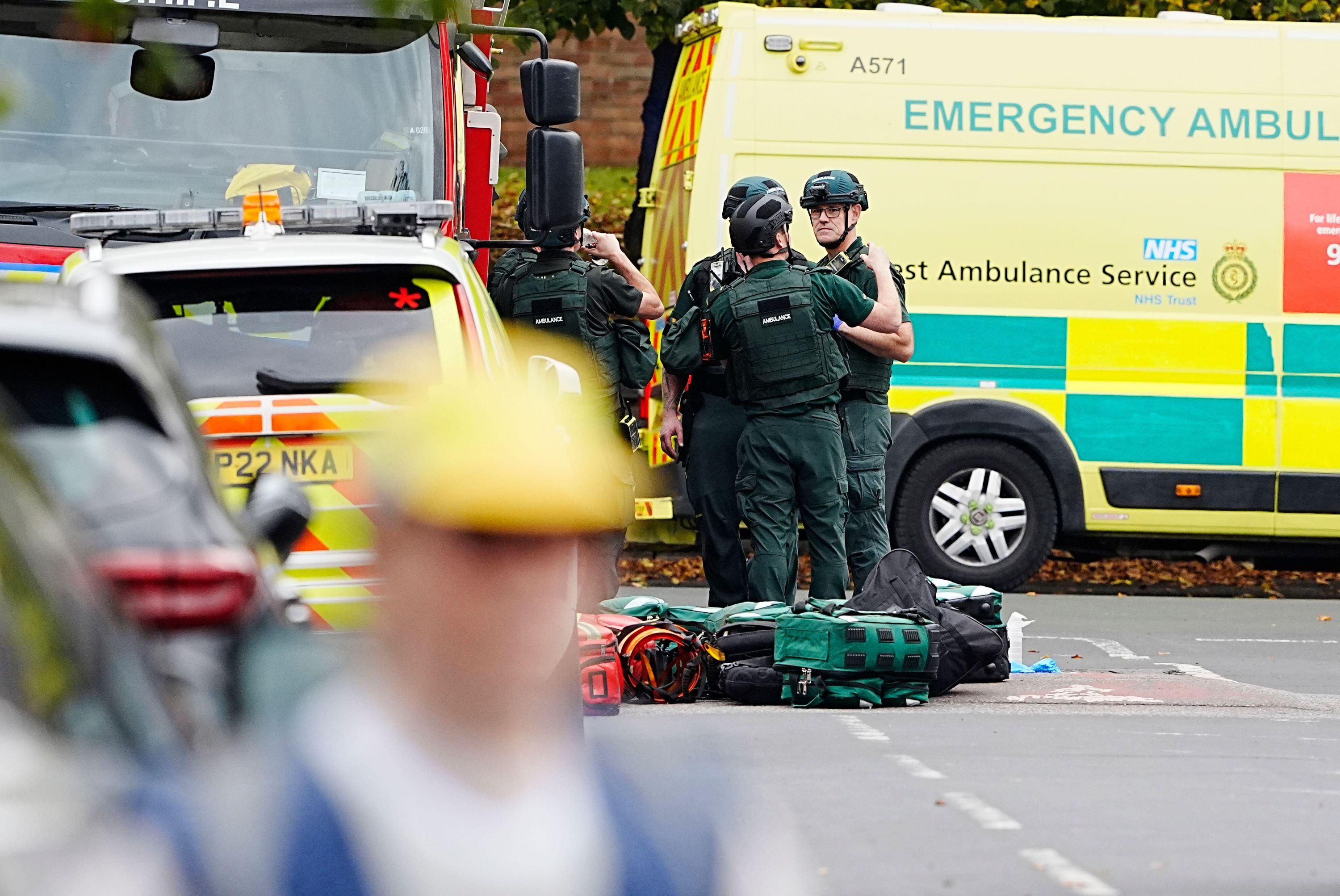 Paramedics talking in front of ambulance in the road 