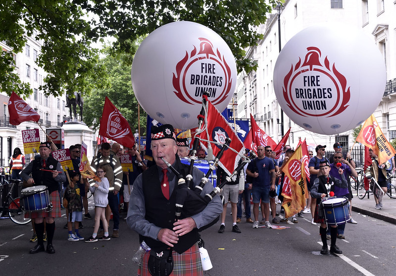 FBU piper with FBU balloons at rally
