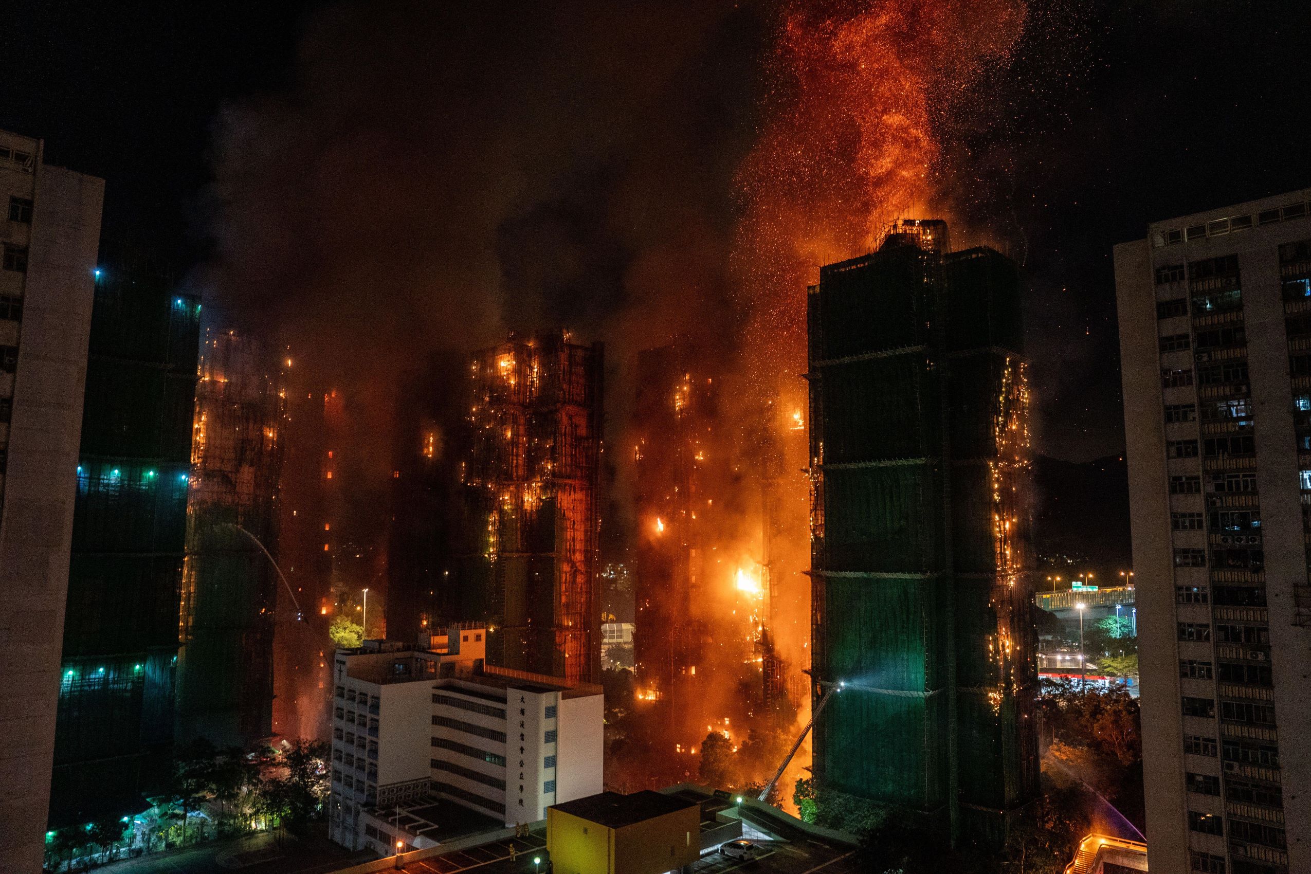 A huge fire rages across multiple apartment blocks