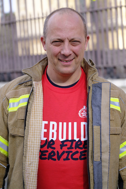 Miles Stubbs smiles in rebuild our fire service t shirt with firefighter tunic