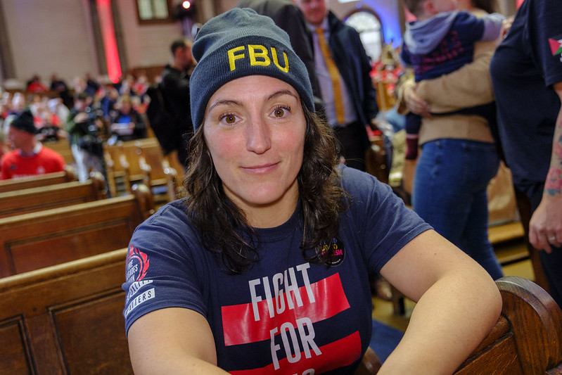 Leoni Munslow smiles at the camera wearing an FBU beanie hat