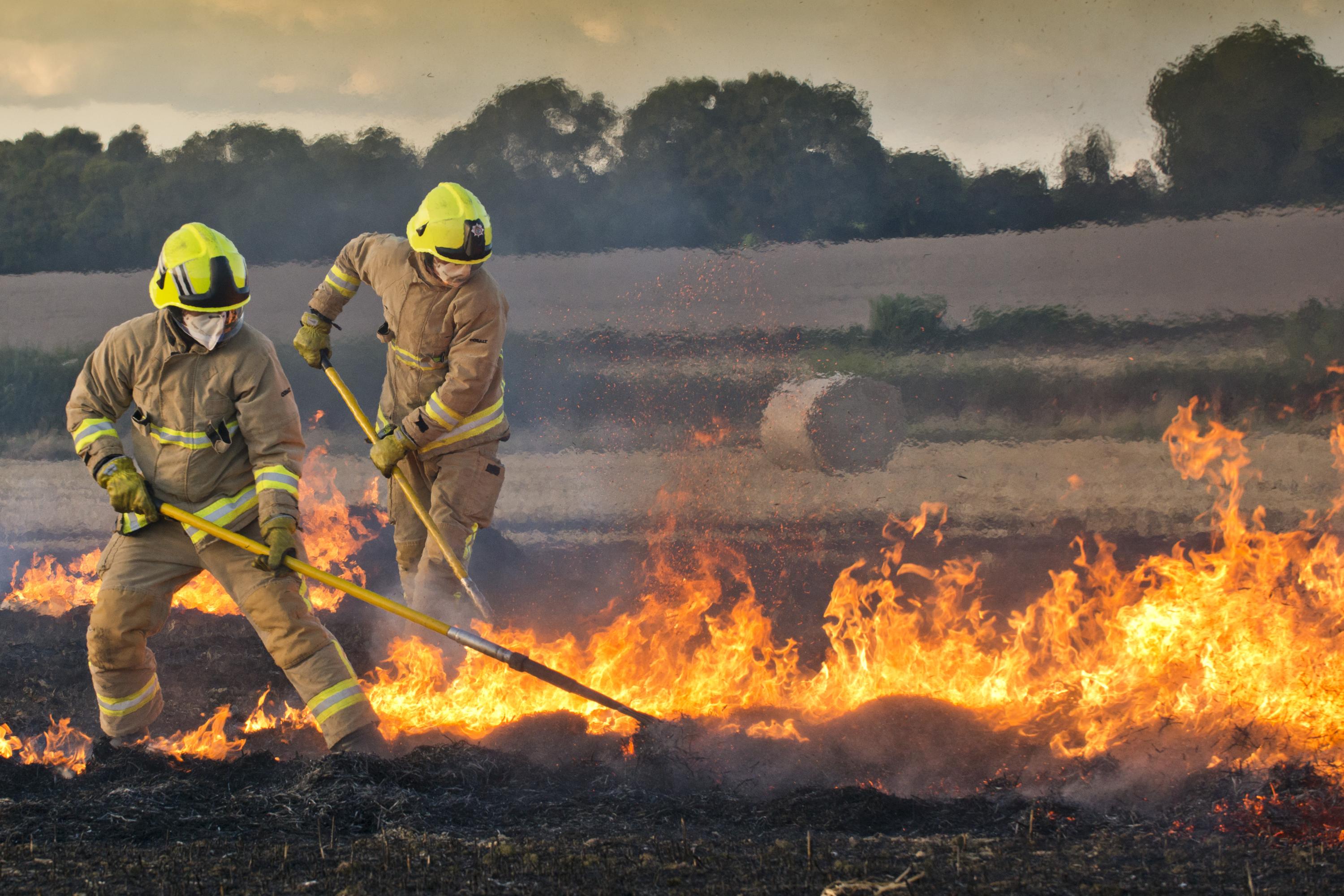 Firefighters beating field fire by Eddie Howland