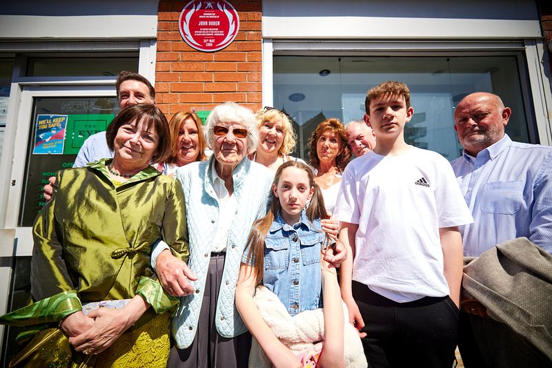 Members of John's family with the plaque 