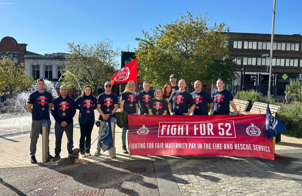 FBU members hold Fight 52 banner outside fire authority building