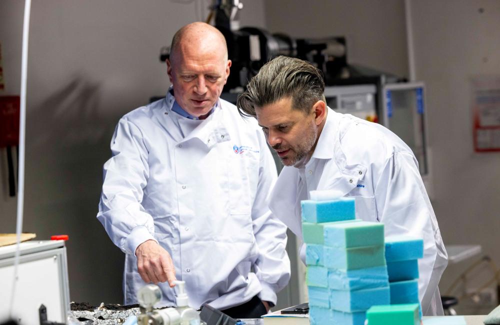 Matt Wrack and Riccardo la Torre in lab coats at the university of central lancashire