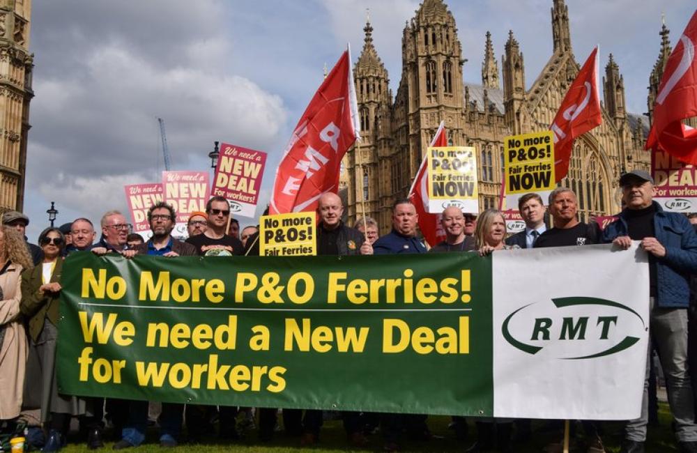 RMT members outside parliament with a banner saying: No more P&O ferries! We need a new deal for workers"