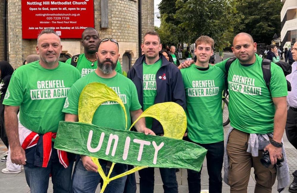 Steve Wright and FBU officials hold a 'unity' placard at the Grenfell silent walk