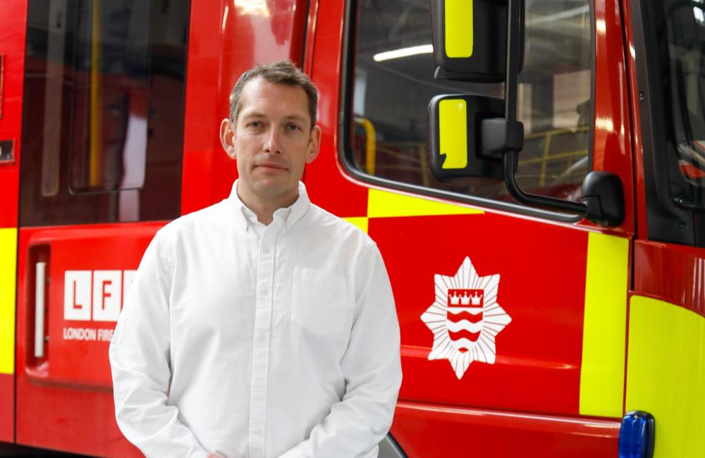 Steve Wright standing in front of a fire engine at Kingston fire station