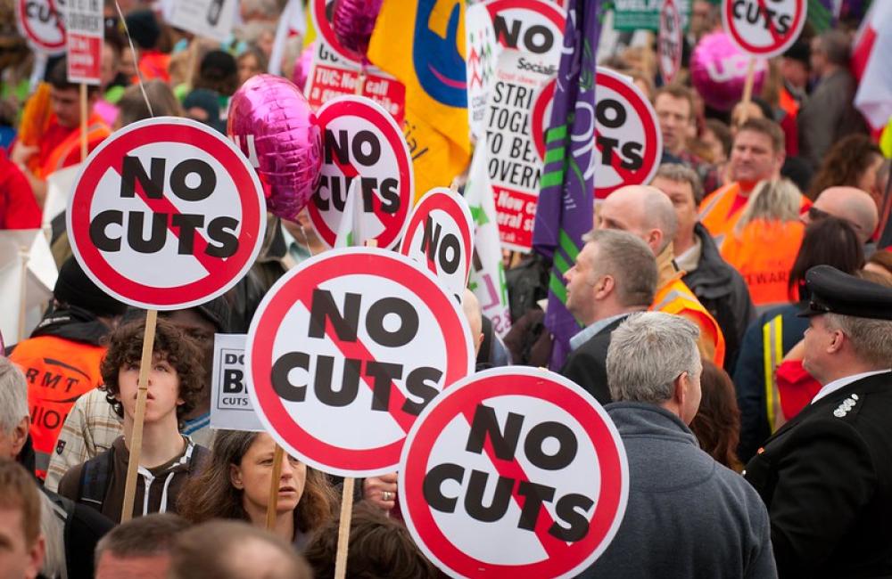 Protestors hold 'no cuts' placards