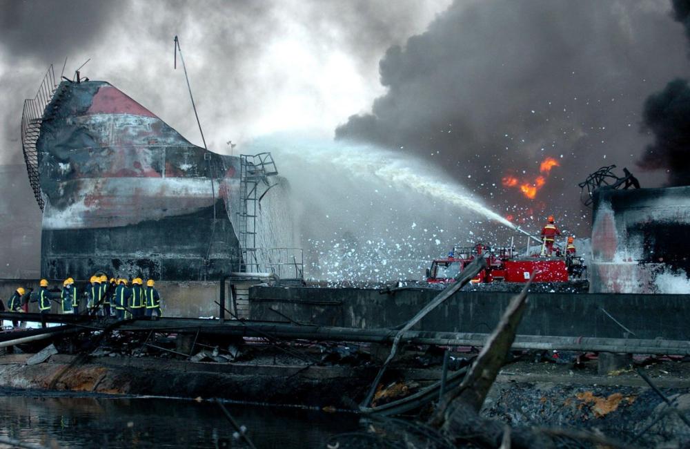 Firefighters fighting Buncefield fire with foam
