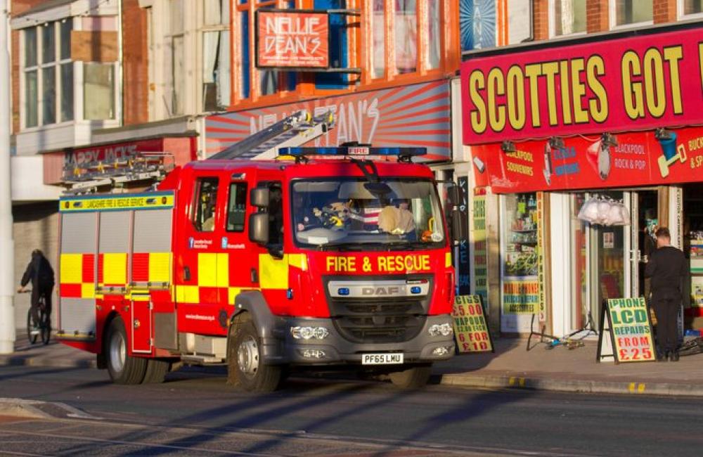 A fire engine in Blackpool outside a colourful arcade