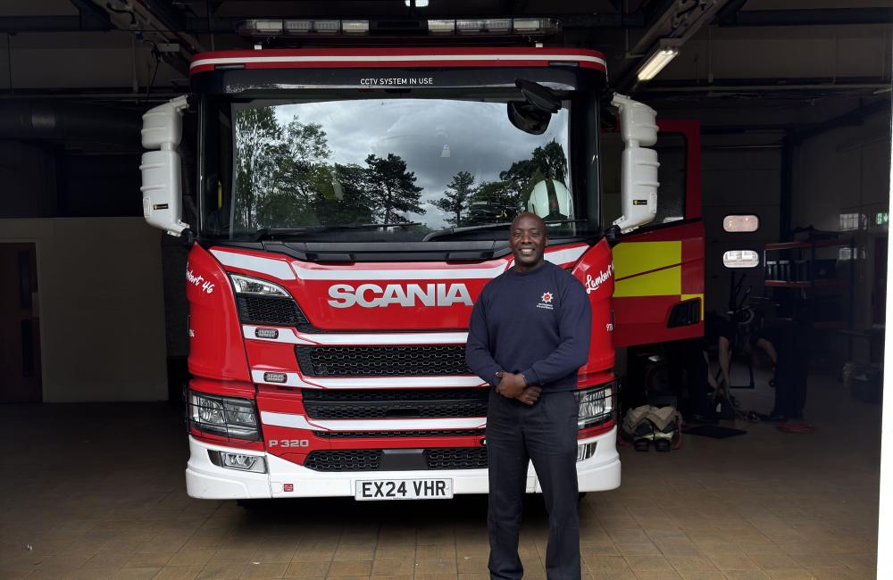 Dwight Williams standing next to a fire engine