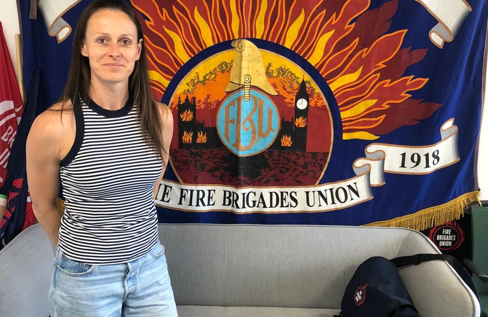 Annabel Green in front of the Fire Brigades Union national banner