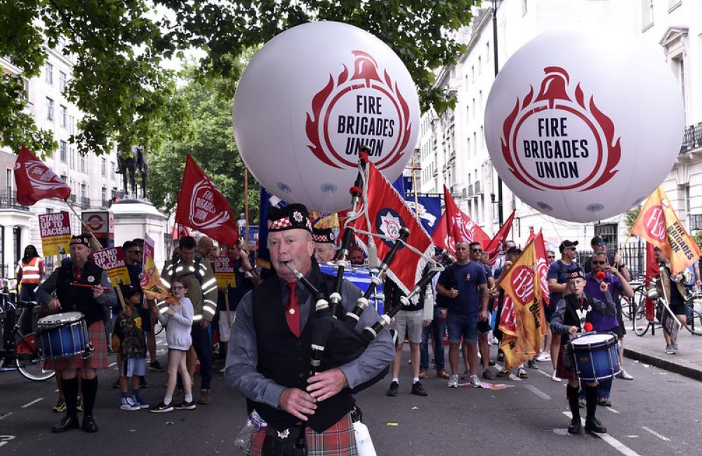 FBU piper with FBU balloons at rally