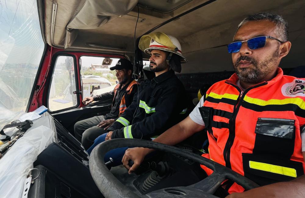 Two firefighter driving a fire appliance with a cracked windscreen