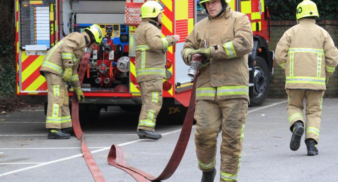 Firefighters pulling our hose appliance