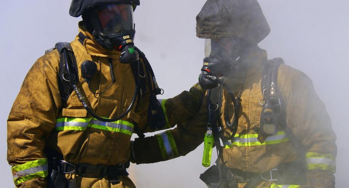 two firefighters smoke