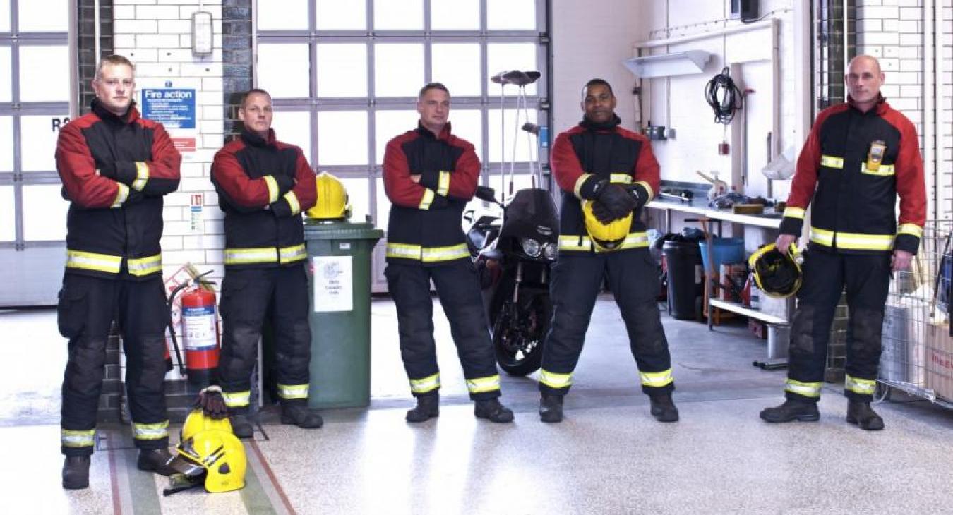 5 five firefighters standing station