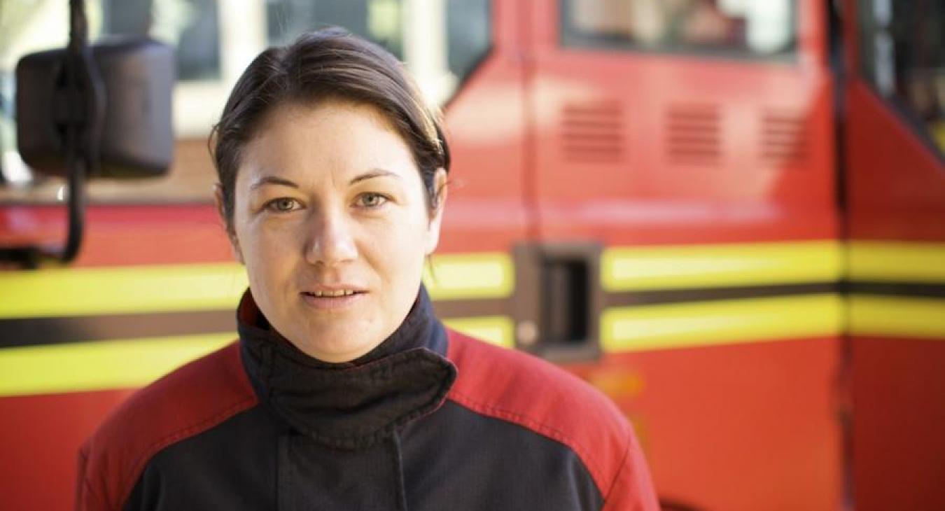 female-firefighter-by-engine