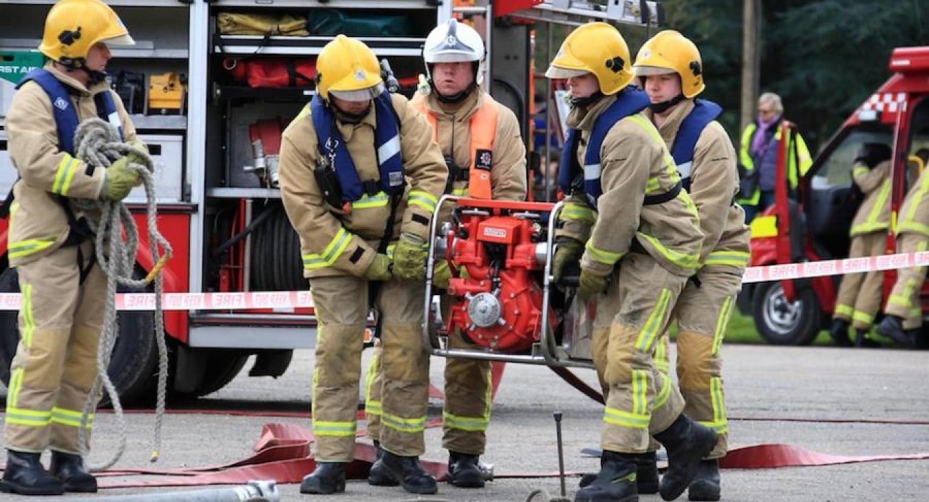 firefighters-carrying-water-pump