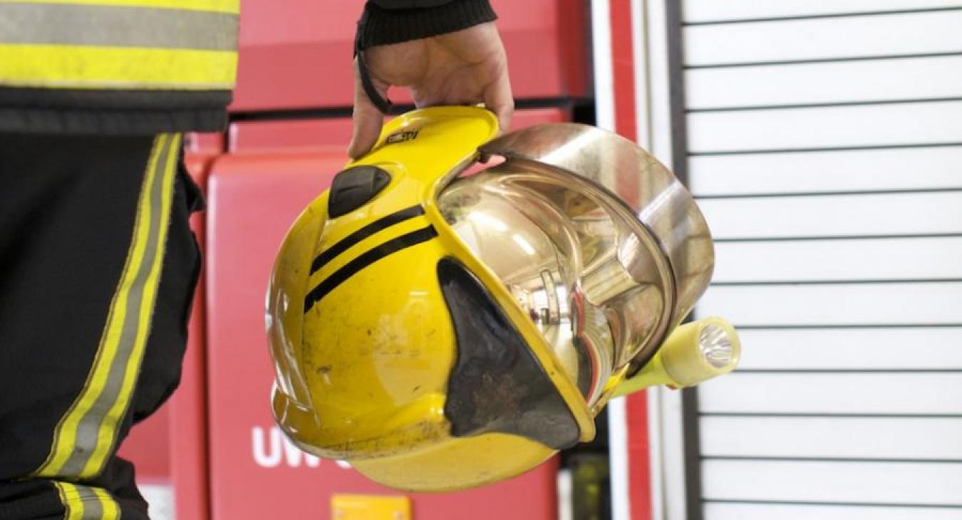holding-fire-helmet