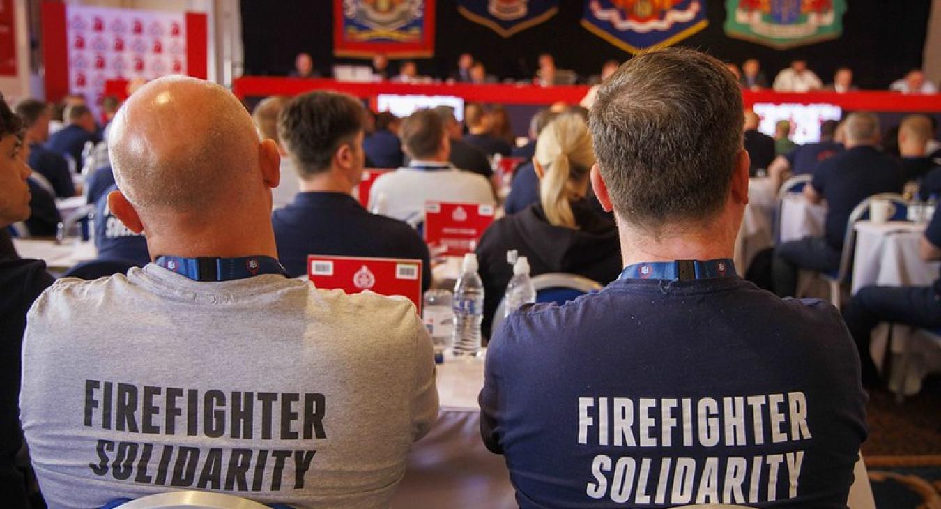 Two firefighters wearing firefighter solidarity t-shirts