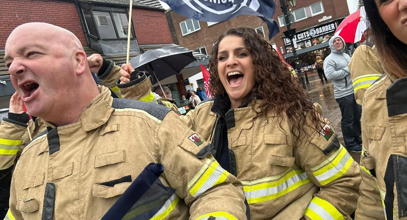 Firefighters chanting at a rally 