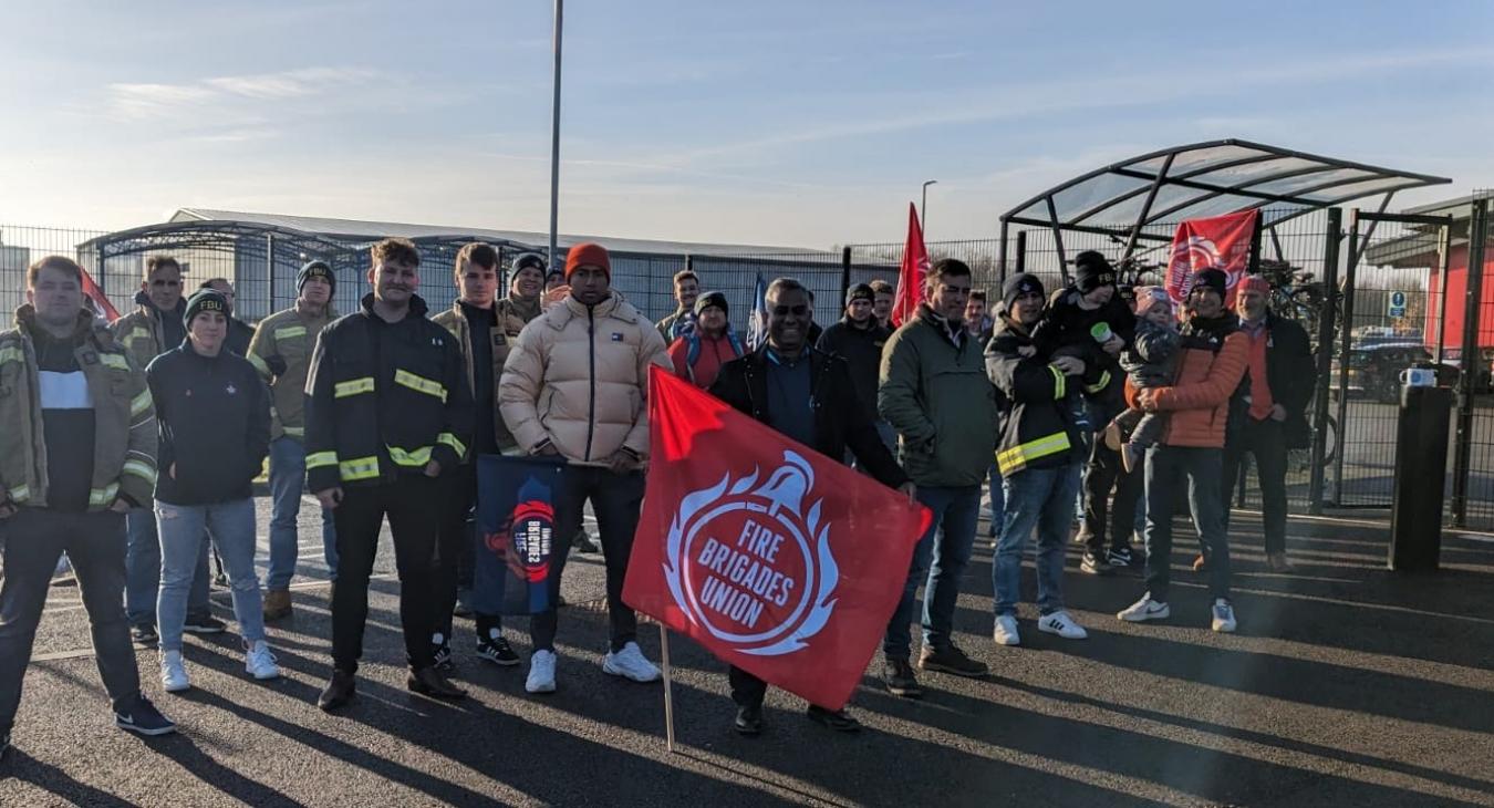 Firefighters gather outside fire authority meeting